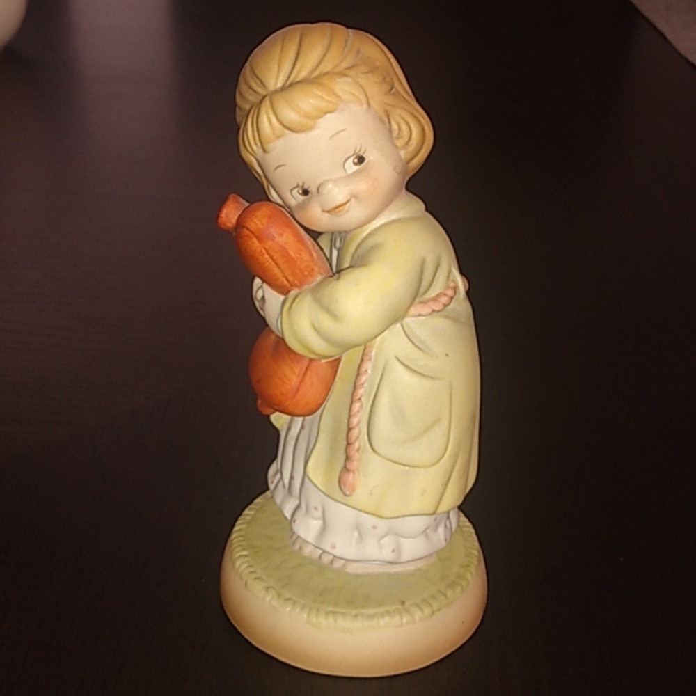 Lucie Atwell "we all love a cuddle" girl hugging a hot water bottle figurine 90s